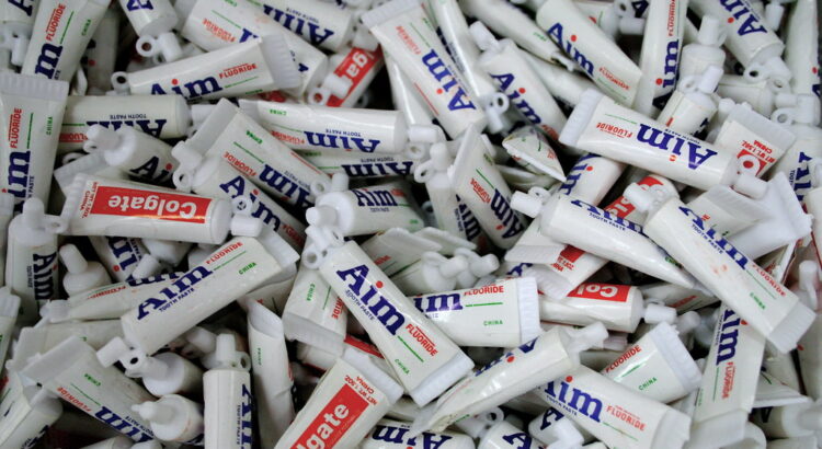 Hundreds of travel toothpaste tubes in a pile