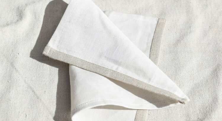 Photo of a white handkerchief on a white linen background