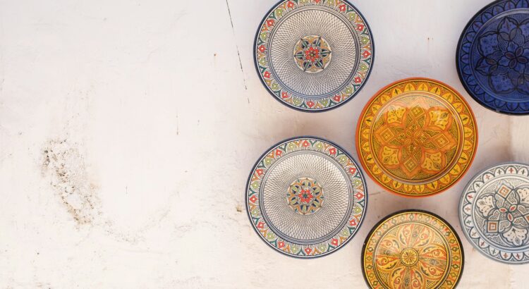Six assorted colored plates on a white background